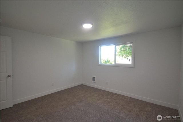 64 Queets St, Steilacoom, WA 98388 - empty room featuring dark colored carpet and baseboards