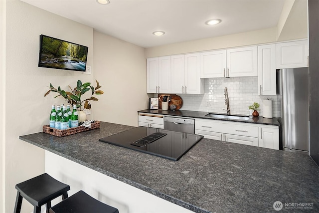 2345 42nd Ave E, Seattle, WA 98112 - kitchen with a sink, appliances with stainless steel finishes, decorative backsplash, white cabinetry, and a peninsula