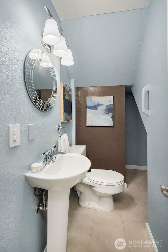 2345 42nd Ave E, Seattle, WA 98112 - bathroom featuring tile patterned floors, toilet, and baseboards