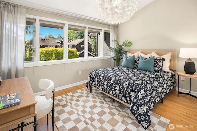 2345 42nd Ave E, Seattle, WA 98112 - bedroom with wood finished floors, baseboards, and a chandelier