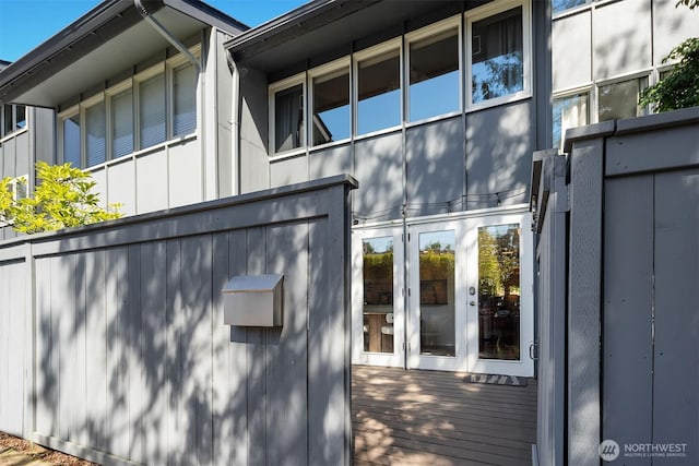 2345 42nd Ave E, Seattle, WA 98112 - view of property exterior featuring french doors, board and batten siding, and a deck