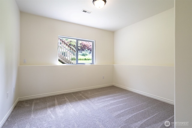 carpeted spare room with baseboards