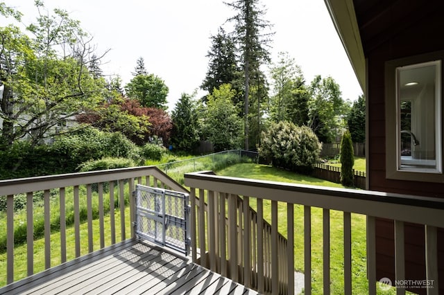 deck featuring view of wooded area