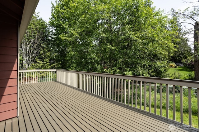 wooden deck featuring view of scattered trees