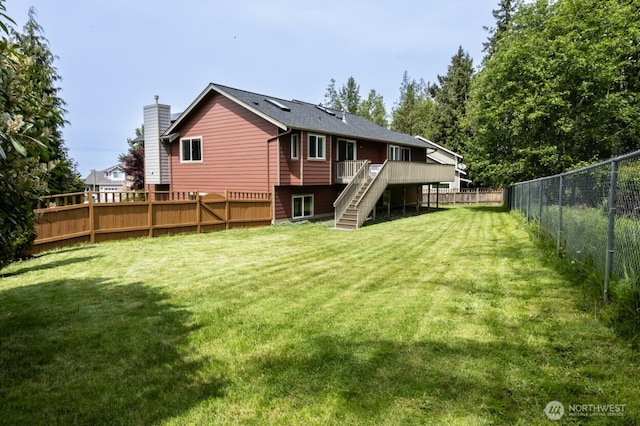 rear view of property with stairs, a wooden deck, and a chimney