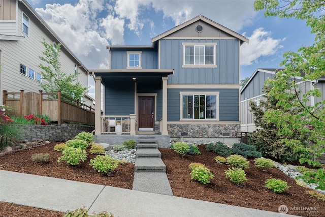 27815 NE 148th Ln, Duvall, WA 98019 - view of front of property featuring board and batten siding, fence, a porch, and stone siding