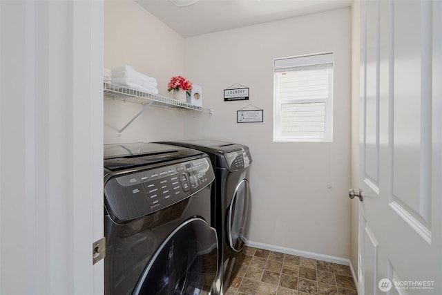 27815 NE 148th Ln, Duvall, WA 98019 - washroom featuring washing machine and clothes dryer, baseboards, and stone finish flooring