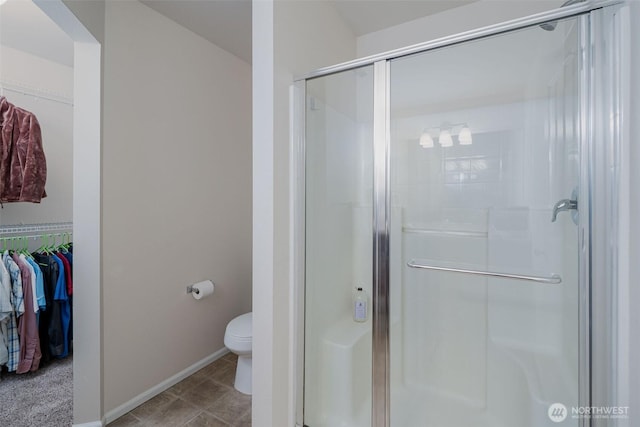 27815 NE 148th Ln, Duvall, WA 98019 - full bathroom with a stall shower, baseboards, toilet, and a walk in closet