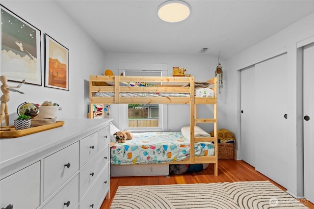 bedroom with light wood-style floors and a closet