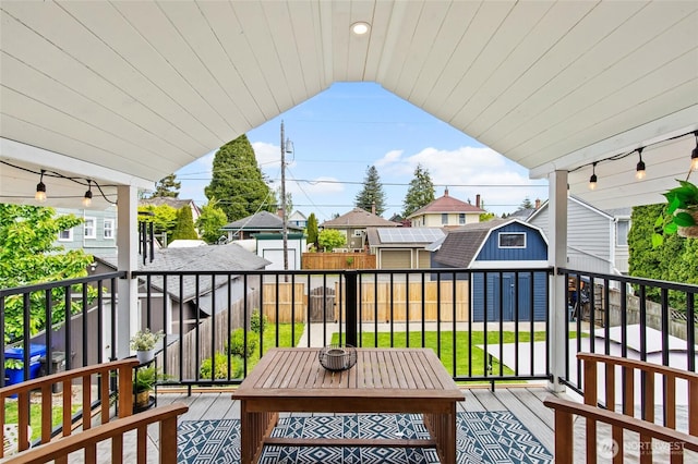 view of wooden balcony featuring a deck and a residential view