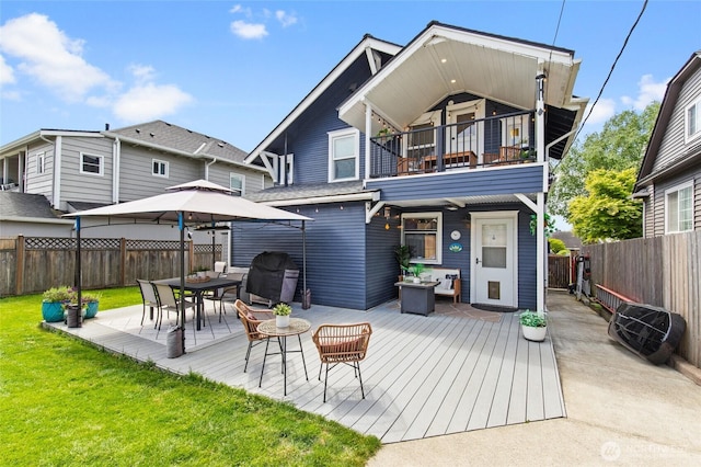 back of house featuring a balcony, a patio, and a deck