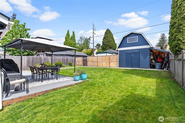 view of yard featuring a shed, an outdoor structure, a patio, and a gazebo