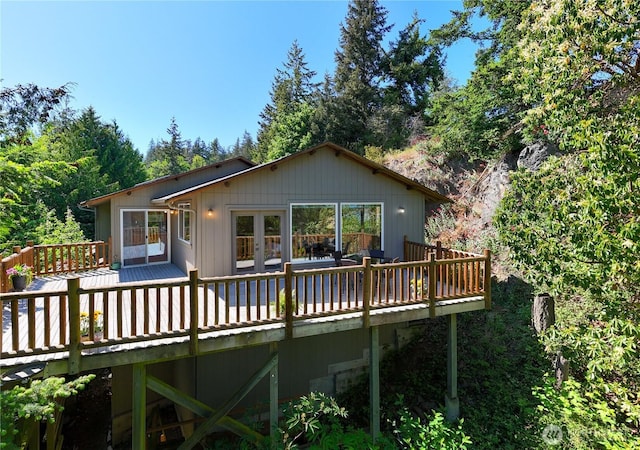 rear view of house with a deck and french doors