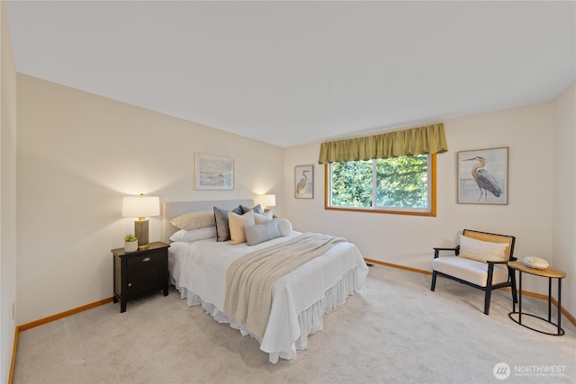 bedroom featuring baseboards and light carpet