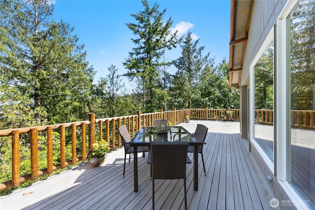 wooden terrace with outdoor dining space