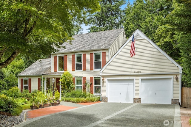 21842 NE 30th Pl, Sammamish, WA 98074 - colonial house featuring asphalt driveway, an attached garage, and stone siding
