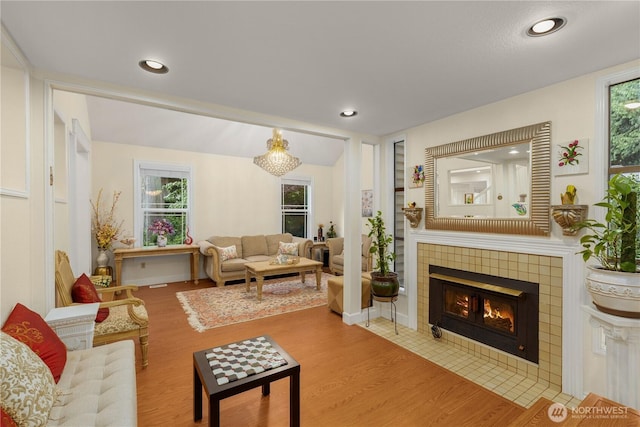 21842 NE 30th Pl, Sammamish, WA 98074 - living room featuring wood finished floors, a tiled fireplace, recessed lighting, and built in shelves