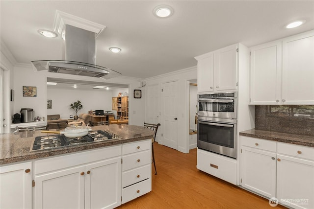 21842 NE 30th Pl, Sammamish, WA 98074 - kitchen with appliances with stainless steel finishes, island range hood, white cabinets, ornamental molding, and light wood finished floors