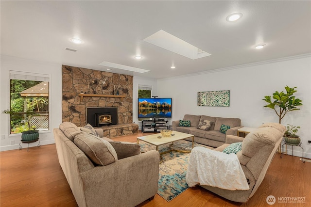 21842 NE 30th Pl, Sammamish, WA 98074 - living area featuring a skylight, wood finished floors, a fireplace, recessed lighting, and crown molding