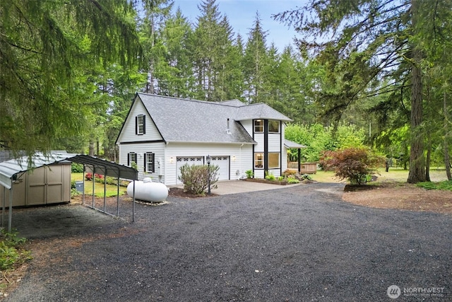 13212 Wicks End Ln SW, Port Orchard, WA 98367 - view of front facade featuring driveway, an attached garage, a shingled roof, and view of wooded area