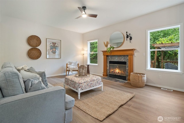13212 Wicks End Ln SW, Port Orchard, WA 98367 - living room with a ceiling fan, a high end fireplace, wood finished floors, and baseboards