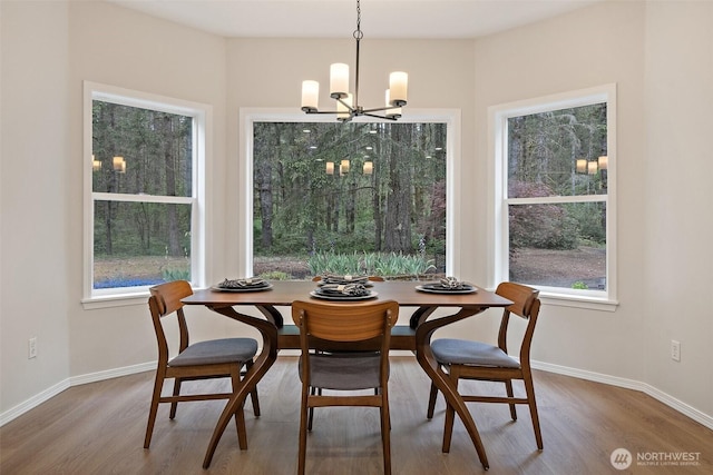 13212 Wicks End Ln SW, Port Orchard, WA 98367 - dining room with a chandelier, wood finished floors, and baseboards