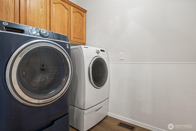 13212 Wicks End Ln SW, Port Orchard, WA 98367 - laundry room with washing machine and dryer, cabinet space, and wood finished floors