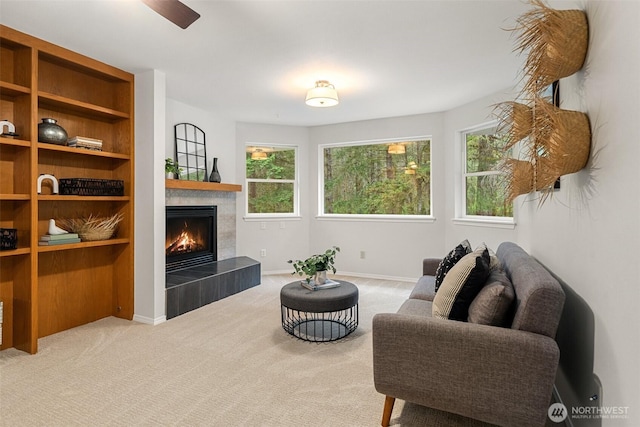 13212 Wicks End Ln SW, Port Orchard, WA 98367 - carpeted living area featuring a tiled fireplace, plenty of natural light, and baseboards