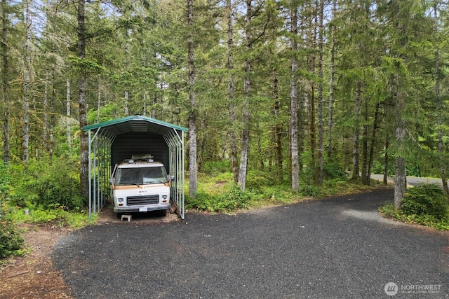 13212 Wicks End Ln SW, Port Orchard, WA 98367 - view of vehicle parking featuring a forest view, a detached carport, and asphalt driveway