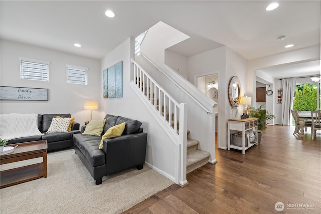 living area featuring stairs, recessed lighting, hardwood / wood-style flooring, and baseboards