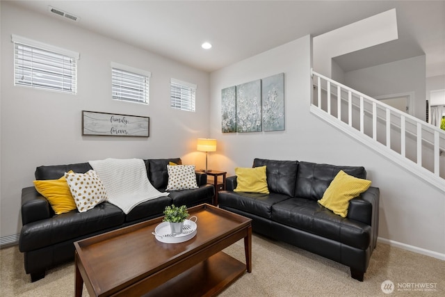 carpeted living area with stairs, baseboards, and recessed lighting