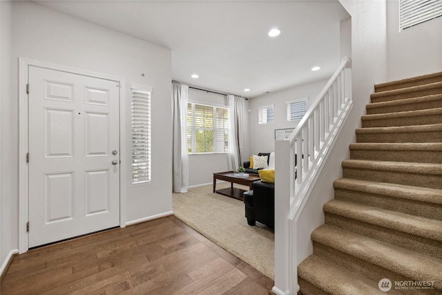 foyer entrance featuring stairs, wood finished floors, recessed lighting, and baseboards