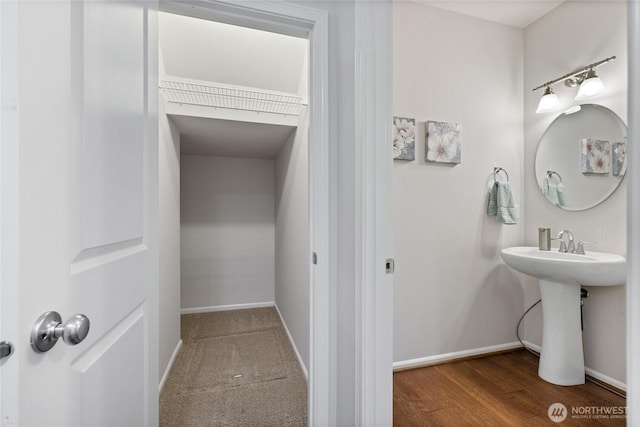 bathroom with baseboards and wood finished floors