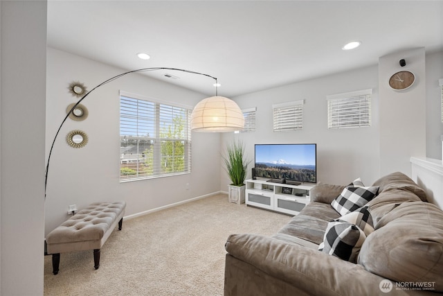 carpeted living room featuring baseboards and recessed lighting