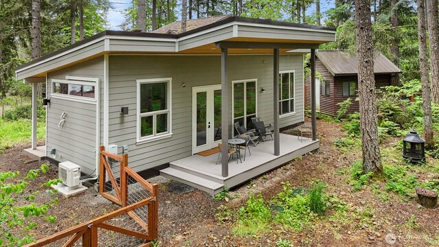 22717 Briarwood Ct SE, Yelm, WA 98597 - rear view of house featuring french doors, a cooling unit, and a wooden deck