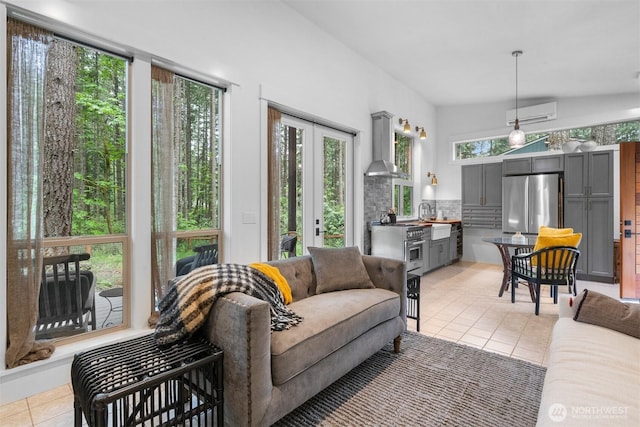 22717 Briarwood Ct SE, Yelm, WA 98597 - living area with light tile patterned floors, a wall mounted AC, and french doors