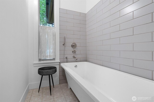 22717 Briarwood Ct SE, Yelm, WA 98597 - full bathroom with a freestanding tub, tile patterned floors, and baseboards