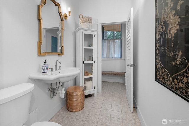 22717 Briarwood Ct SE, Yelm, WA 98597 - half bathroom with toilet, tile patterned floors, and baseboards