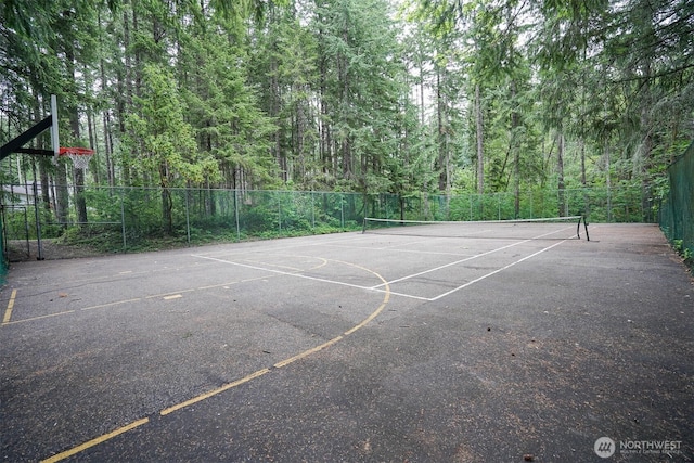 22717 Briarwood Ct SE, Yelm, WA 98597 - view of sport court featuring fence, a tennis court, and a wooded view