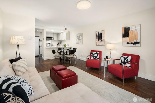 living area featuring wood finished floors and baseboards