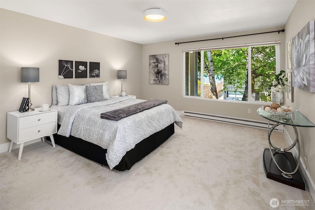 carpeted bedroom with a baseboard heating unit and baseboards