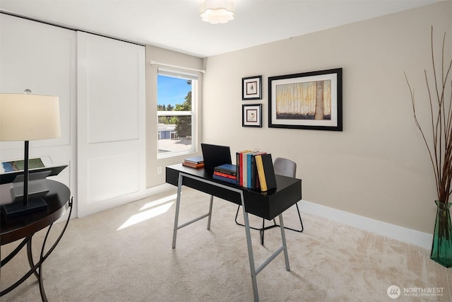 carpeted office with baseboards
