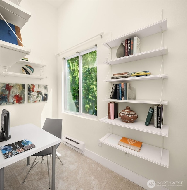 office space with a baseboard heating unit, carpet floors, and baseboards