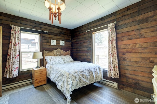 531 3rd St, Ronald, WA 98940 - bedroom featuring a baseboard radiator, multiple windows, wooden walls, and wood finished floors