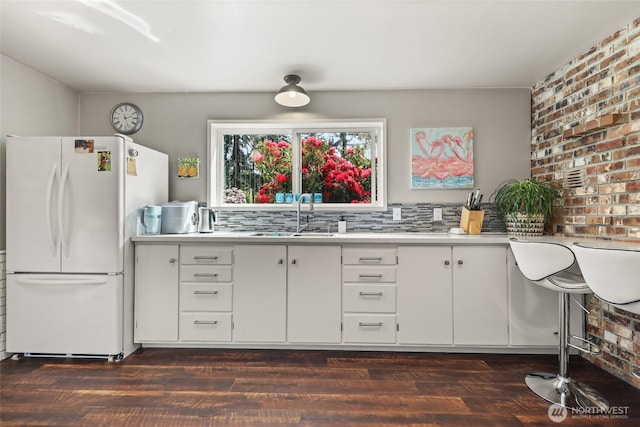 27428 97th Ave SW, Vashon, WA 98070 - kitchen featuring freestanding refrigerator, a sink, light countertops, dark wood-type flooring, and white cabinets
