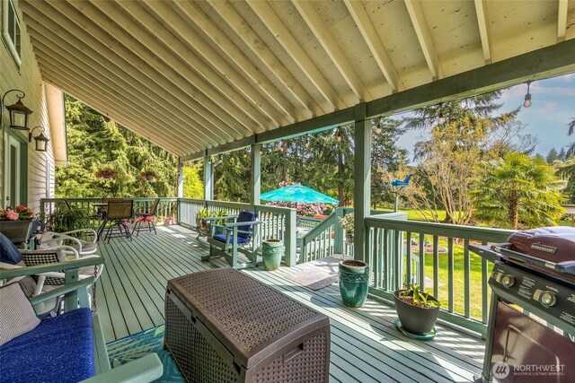 27428 97th Ave SW, Vashon, WA 98070 - wooden deck with grilling area, outdoor dining space, and a lawn