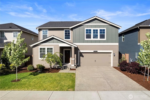 view of front of home with board and batten siding, an attached garage, driveway, and a front lawn