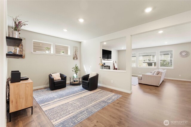 sitting room with wood finished floors, recessed lighting, and baseboards