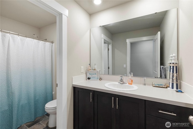 bathroom featuring vanity, toilet, a shower with shower curtain, and tile patterned floors