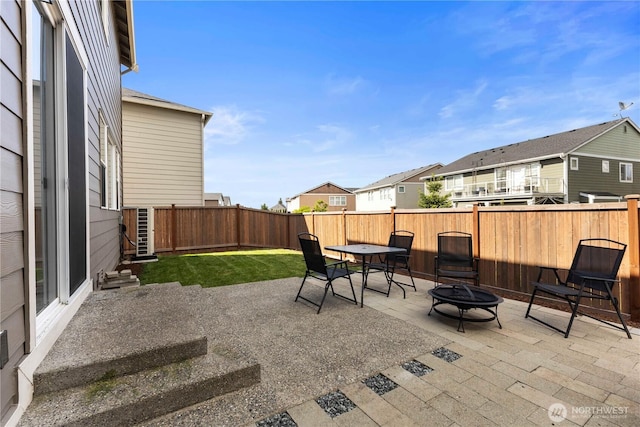 view of patio / terrace with an outdoor fire pit and a residential view